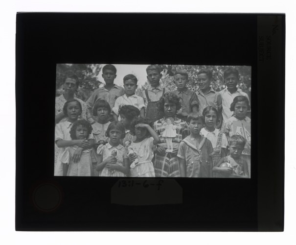 Black-and-white glass lantern slide of a group portrait of Creek children, Alabama.