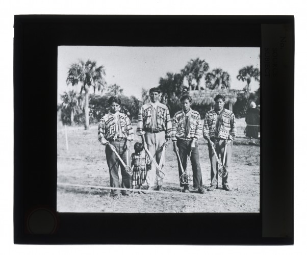 Black-and-white glass lantern slide portrait of Seminole stickball players.