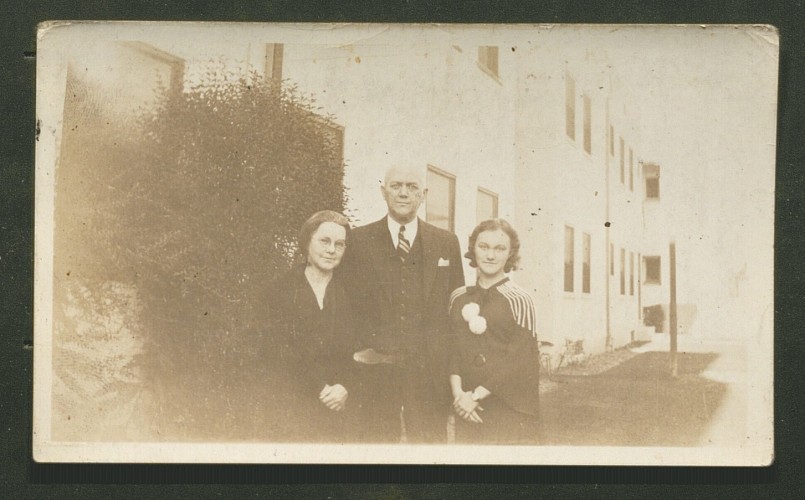 black and white photo of woman, man, and young woman standing for portrait